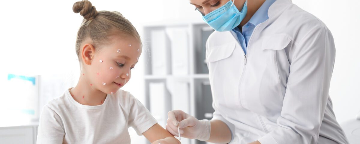 Doctor Applying Cream Onto Skin Of Little Girl With Chickenpox I