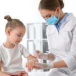 Doctor Applying Cream Onto Skin Of Little Girl With Chickenpox I