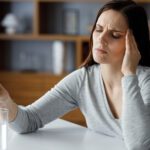 Upset Young Woman Suffering From Headache Using Soluble Drug For