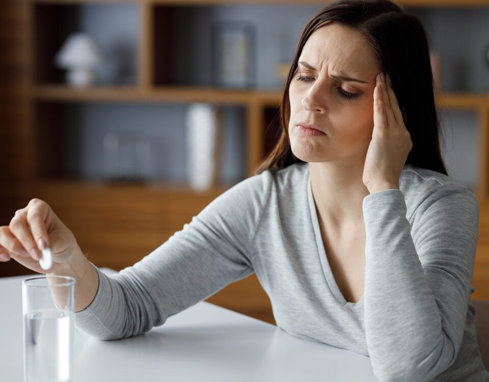 Upset Young Woman Suffering From Headache Using Soluble Drug For